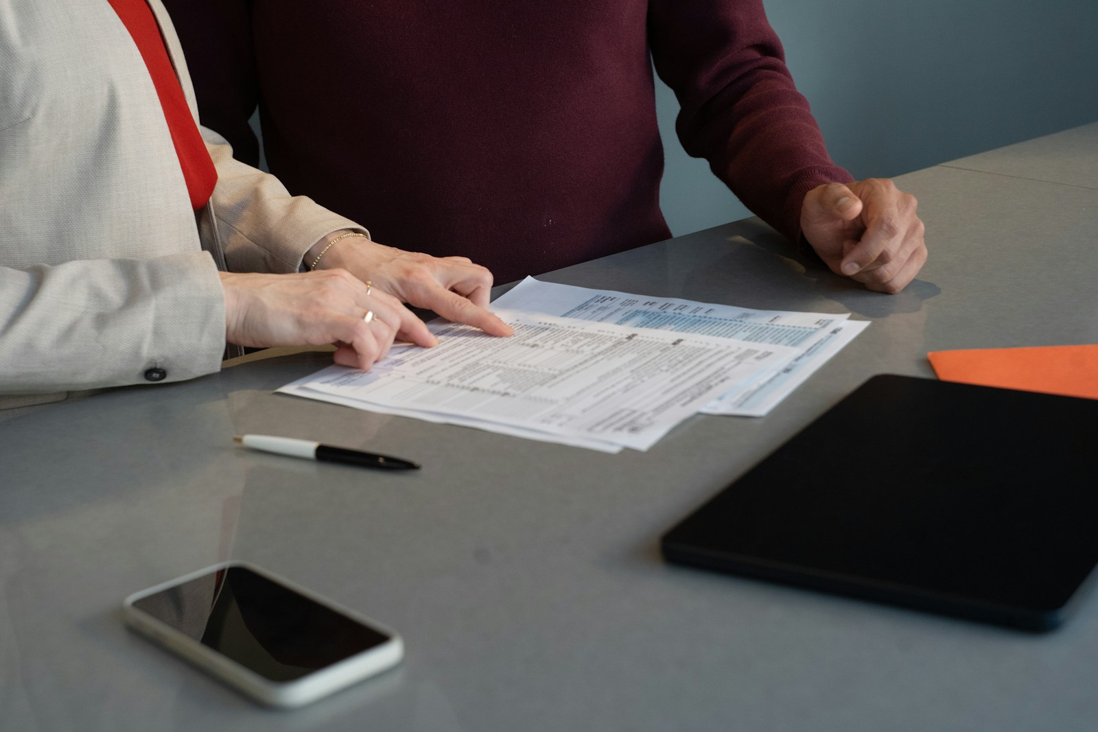 Two people reviewing business documents together